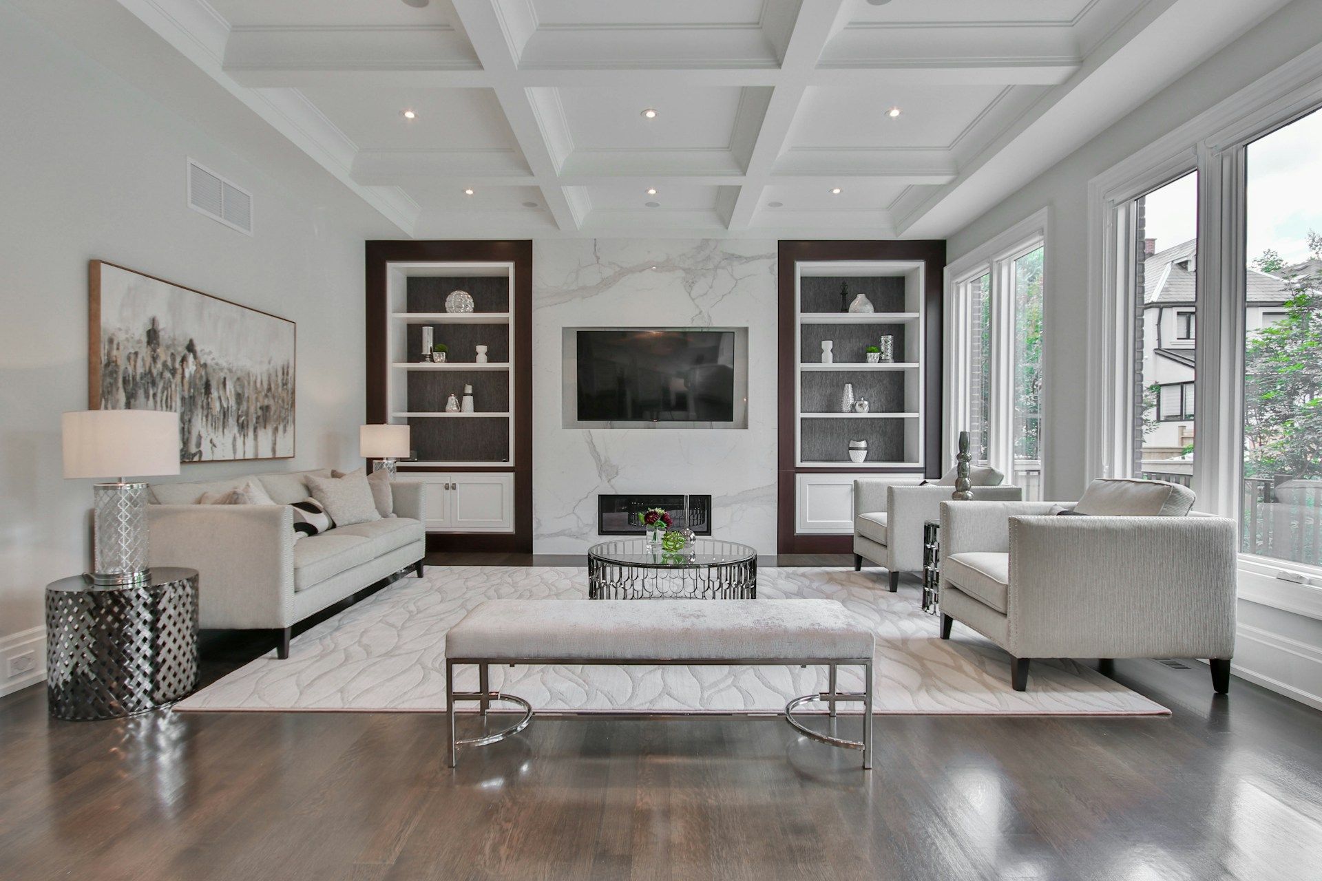 A finished CDG living room with coffered ceiling and built-in shelving